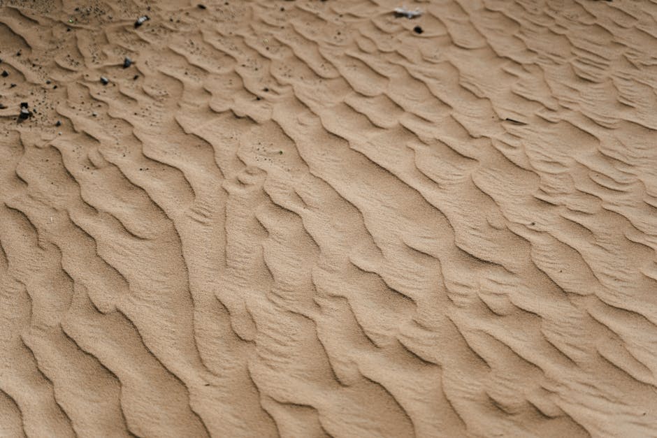 A close-up view of textured sand dunes in a tranquil desert environment.